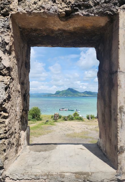 A stone doorway framing a turquoise bay